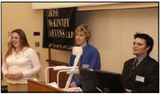 Three students present a project. 
